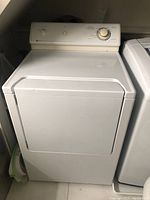 Front view of white Maytag front-loading dryer
