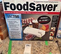 Photo of original boxed FoodSaver VAC750 home vacuum packaging system showing vacuum sealer and packaging information.