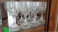 Set of thick stemmed goblet-style glasses with refractive vertical cuts on glass bodies.