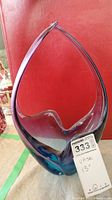 Full view of the glass vase showing its shape, color gradient from blue to purple, and thick base.
