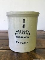 Front view of the 1/4 gallon Medalta Potteries stoneware crock with black lettering.