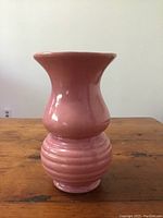 Front view of pink ceramic vase showing shape and glossy glaze.