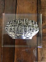 Full front view of acrylic picture with raised sterling silver coated depiction of Jerusalem cityscape with detailed stone walls and towers.