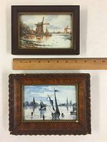 Front view of both framed porcelain plaques side by side with ruler for scale
