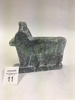 Front side view of one hand carved stone ox sculpture showing detailed carving and marbled stone.