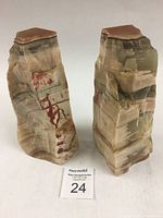Two onyx bookends shown from an angled front side view highlighting stone patterns and colors.