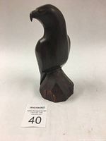 Front and side views of the vintage rosewood bird sculpture showing the carving and base.