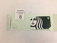 Starbucks gift card on open green backing sleeve showing $30 face value