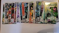 Eighteen DC Comics arranged horizontally showing some issue numbers and colorful covers.