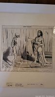 Photo of Honore Daumier lithograph showing two men in a wooden room, with signature and date visible.