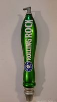 Full view of the green Rolling Rock beer tap handle showing brand name and logo.