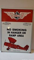 Front view of the Skelly metal sign showing the logo, warning message, and airplane graphic.