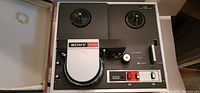 Top view of Sony AV-3600 video recorder showing dual tape reel spools, control panel with buttons and switches, and logo label.