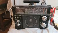 Front view of black Venturer multiband receiver with speaker, tuning dials, and control switches.