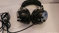 Front side of the vintage Roberts Rheem headphones showing black ear cups with silver dial controls and attached headband