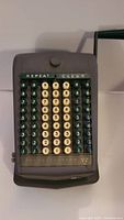 Front view of vintage Todd Protectograph mechanical adding machine with visible keys, branding and buttons.