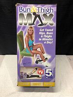 Front of the original box featuring a model sitting on a chair using the Bun & Thigh Max to tone hips, buns and thighs. Shows lightweight, compact and portable features, 5 in 1 exercise functions, and As Seen on TV logo.