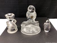 Lot of 3 crystal figurines showing the dove candle holder, owl on frosted deer base, and faceted penguin figurine side by side