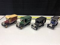 Lot of 4 vintage style diecast beer trucks with measuring tape for scale.