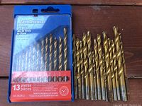 Photo showing 13 pieces titanium drill bit set by Mastercraft in blue plastic case and loose bits