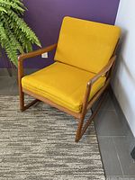 Complete rocker with mustard yellow cushions against purple wall