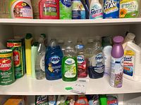 Shelf view of various dish soaps and household cleaning products including Dawn, Great Value, Comet, Lysol, and OxiClean.