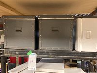 Two gray 12-cube storage boxes and one white collapsible storage box on a shelf