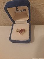 Ring in blue velvet jewelry box, front angle view