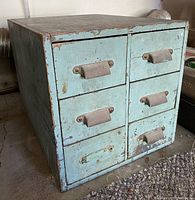 Image of vintage wooden tool chest showing 6 drawers with aged blue paint and one missing drawer handle.