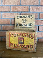 Front and lid of vintage Colman's Mustard wooden box showing branding and label details.