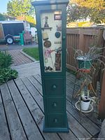 Full view front of golf themed tall storage unit with drawers and cupboard depicting golf-related graphics
