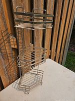 Full view of three-tier metal shower corner shelf showing design and size.