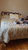 Front view of assembled bed with wood headboard, mattress and bedding