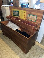 Open view of the heirloom cedar chest showing attached hinged tray and blankets inside.