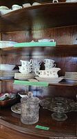 Royal Albert Winsome china displayed on wooden shelves including dinner plates, tea cups, saucers, gravy boat, and other serving dishes.