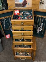 Full view of open top lid, drawers and side doors showing contents