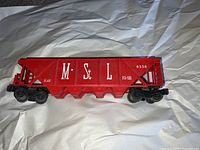 Side view of red M. St L Lionel model train car with number 6536 visible.