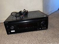 Front and top angled view of Sony DA2800ES AV receiver showing vented top, Sony branding, and front panel controls including volume knob.