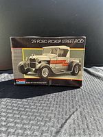 Front of the model kit box showing artwork of the '29 Ford Pickup Street Rod model in silver with orange 'Z' detailing on the side.