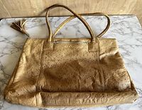 Front view of large vintage Ruth Saltz faux ostrich skin handbag showing texture, handles, and tassel detail.