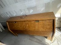 Full frontal view of the headboard showing wood grain, depth, and metal inset handles