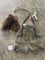 Leather suede lederhosen shorts with suspenders, worn with small stains visible