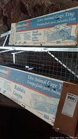 Two boxed Havahart live animal cage traps on shelf: one labeled for small squirrels, the other for rabbits.