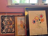 Three framed artworks shown together, highlighting the Picasso flower print and the Escher bird print, plus a third bird drawing