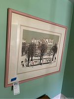 Framed print from an angle showing the artwork and pink frame.