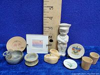 Mixed lot of miniatures including porcelain figurine, wooden shoes, plates, small bowls, and framed picture