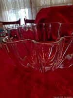 Close up side view of the clear lead crystal bowl showing scalloped rim and vertical ridges.