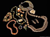 Overview photo showing all 13 pieces of vintage costume jewelry including necklaces, brooches, and earrings on a black background.
