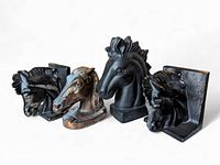 Front view of four vintage horse head bookends in mixed materials showing different sizes and styles