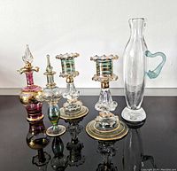 Front view of five vintage glass pieces showing detail and colors.